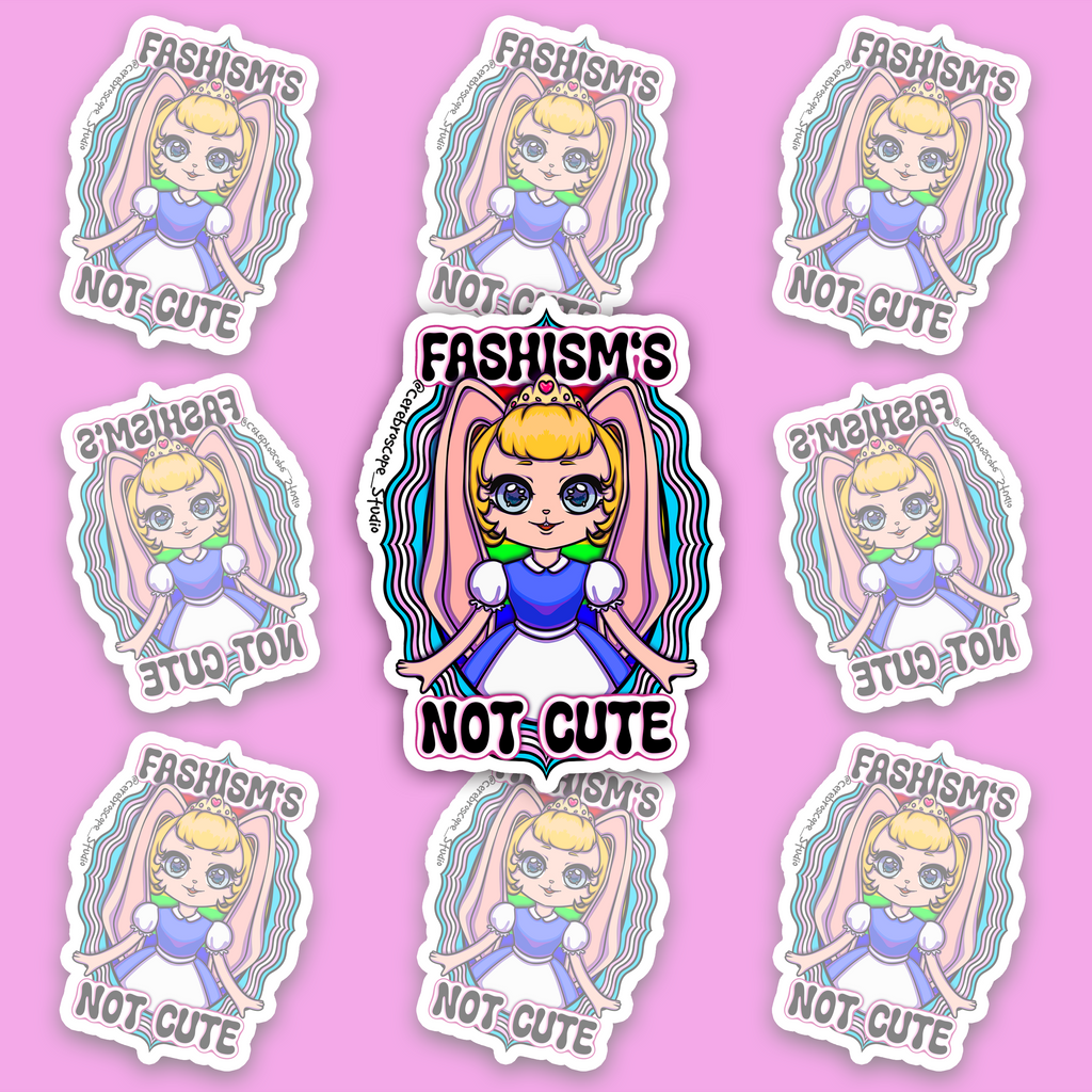 Pastel fantasy character framed by light blue, pink and white Trans Pride colors with the words Fascism’s Not Cute.