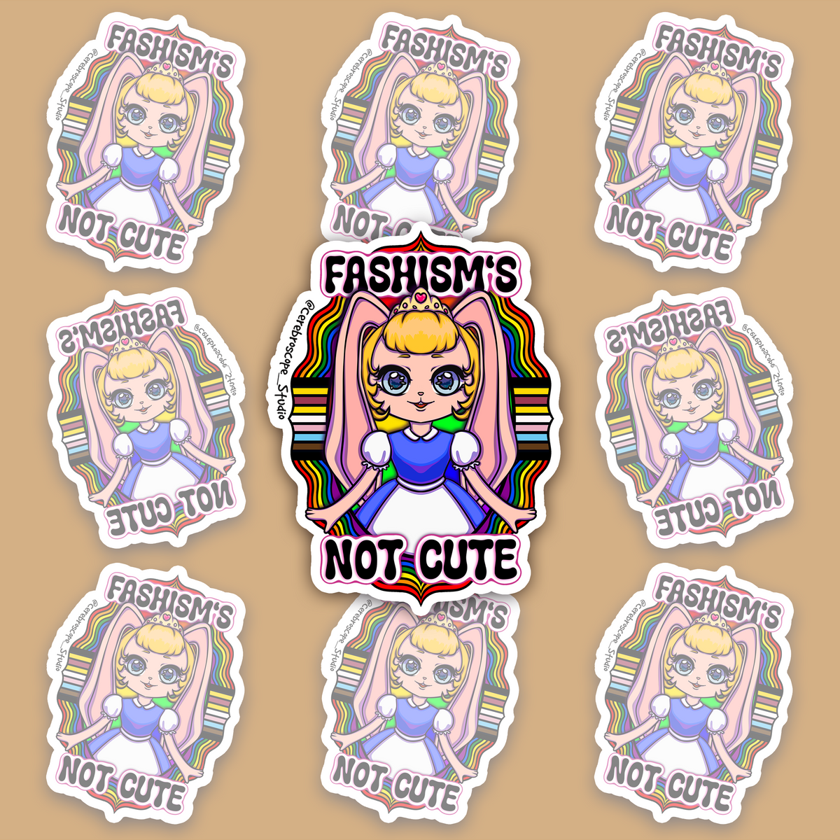 Pastel fantasy character surrounded by rainbow bands and black, brown, blue, pink and white Progress Pride colors with the words Fascism’s Not Cute.