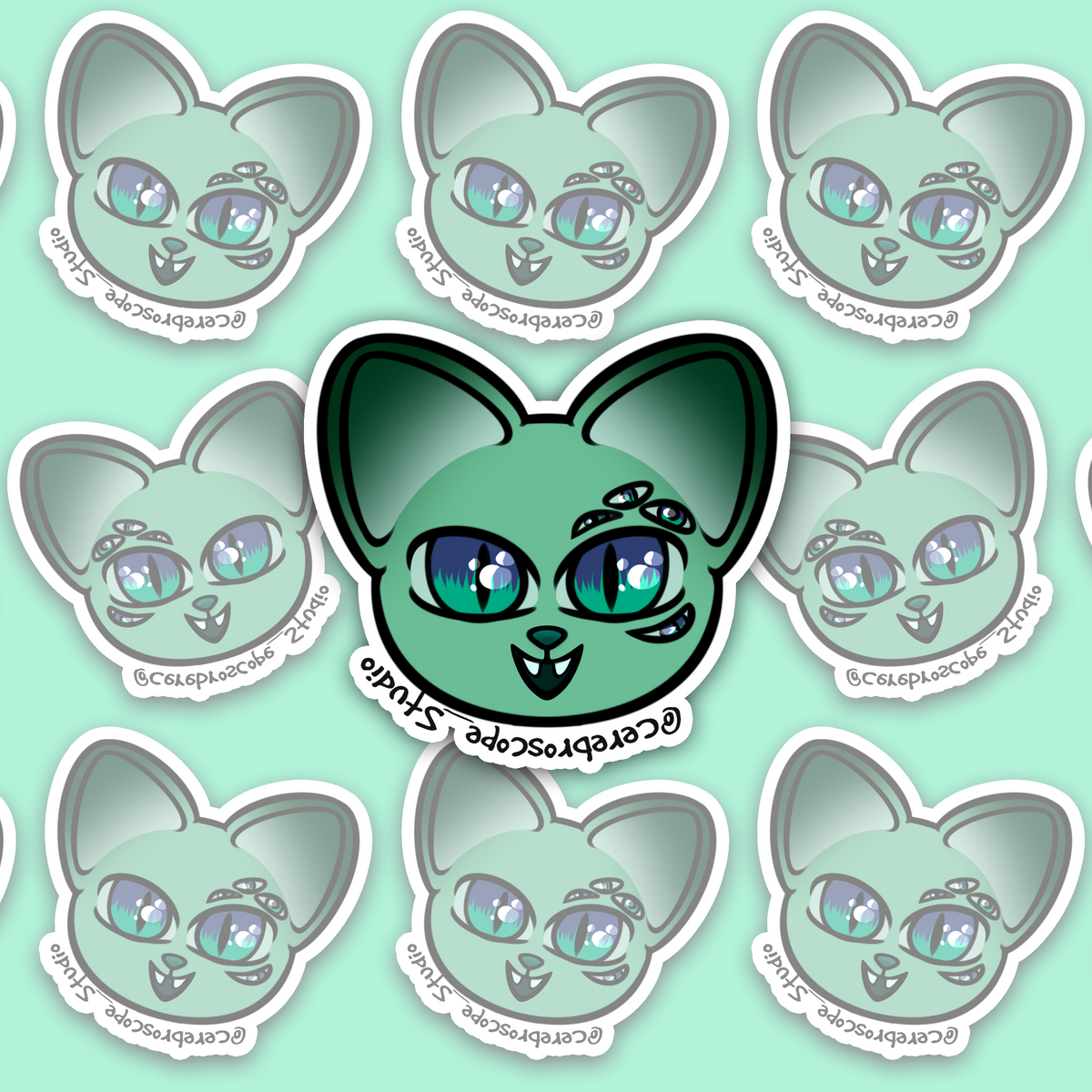 Mint-green cat face with two large blue-green eyes, three smaller eyes above one main eye, another below it, pointed ears and two small white fangs.