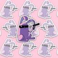 Seated purple-and-pink bunny with long bent ears, two front teeth and black rectangular sunglasses, holding a black pistol in one raised hand.