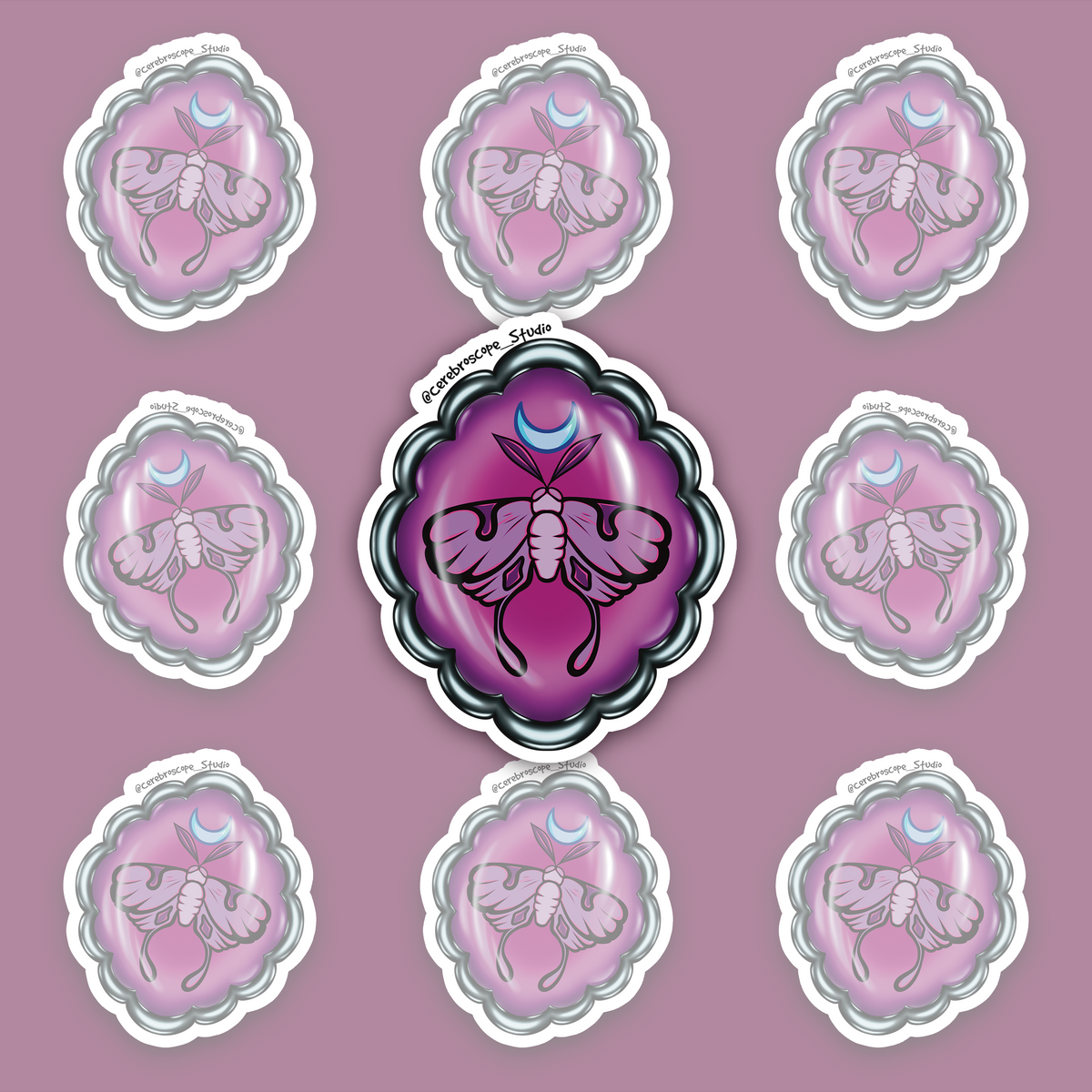 Purple-and-magenta oval medallion with a pink long-tailed moth, a blue crescent above it and a scalloped dark metallic-looking frame.