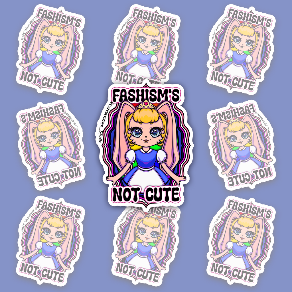 Crowned blonde character with pink bunny ears and a blue-and-white dress, framed by wavy pink, white, purple, black and blue bands and “FASHISM’S NOT CUTE.”